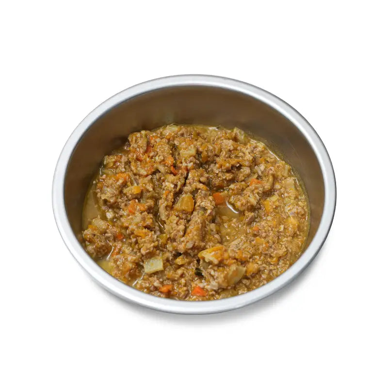 Metal bowl with pet food on a white background