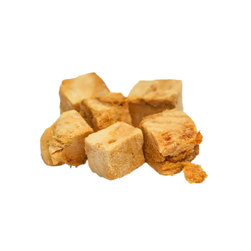 Blocks of brown tofu on a white background