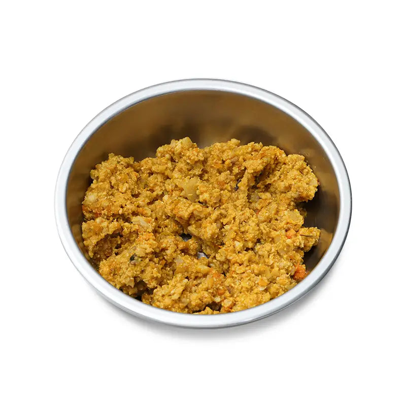 Metal bowl filled with pet food on a white background